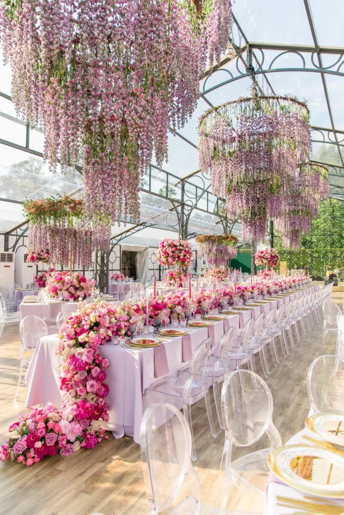 Design and Production: Bespoke Events. Pink, lilac dramatic wedding floral arrangement ceiling.