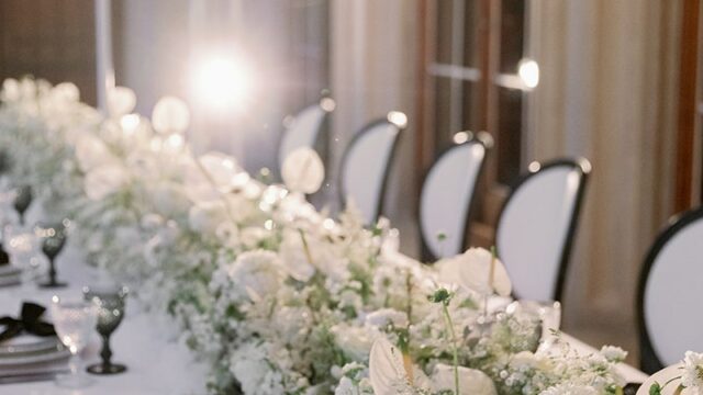 Photographer: Camilla Joy Photography. All White wedding table floral arrangement.