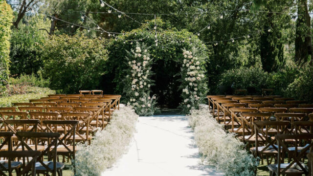 Event Planner: Amanda Costa Thompson. Photographer: Eline Jacobine. Wedding aisle, green floral wedding arch, rustic wedding ceremony.