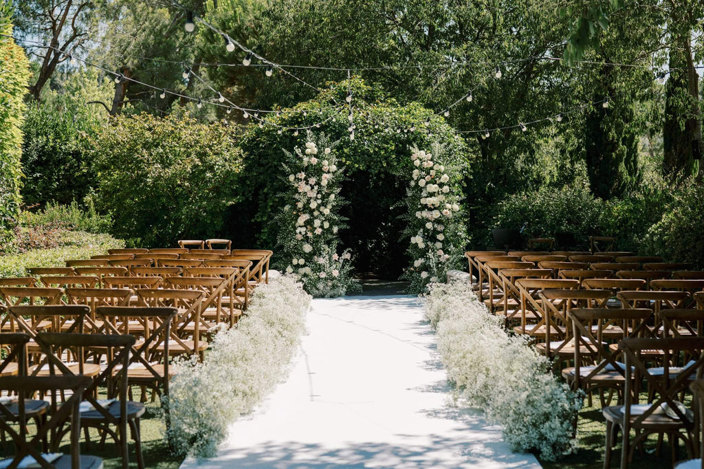 Event Planner: Amanda Costa Thompson. Photographer: Eline Jacobine. Wedding aisle, green floral wedding arch, rustic wedding ceremony.