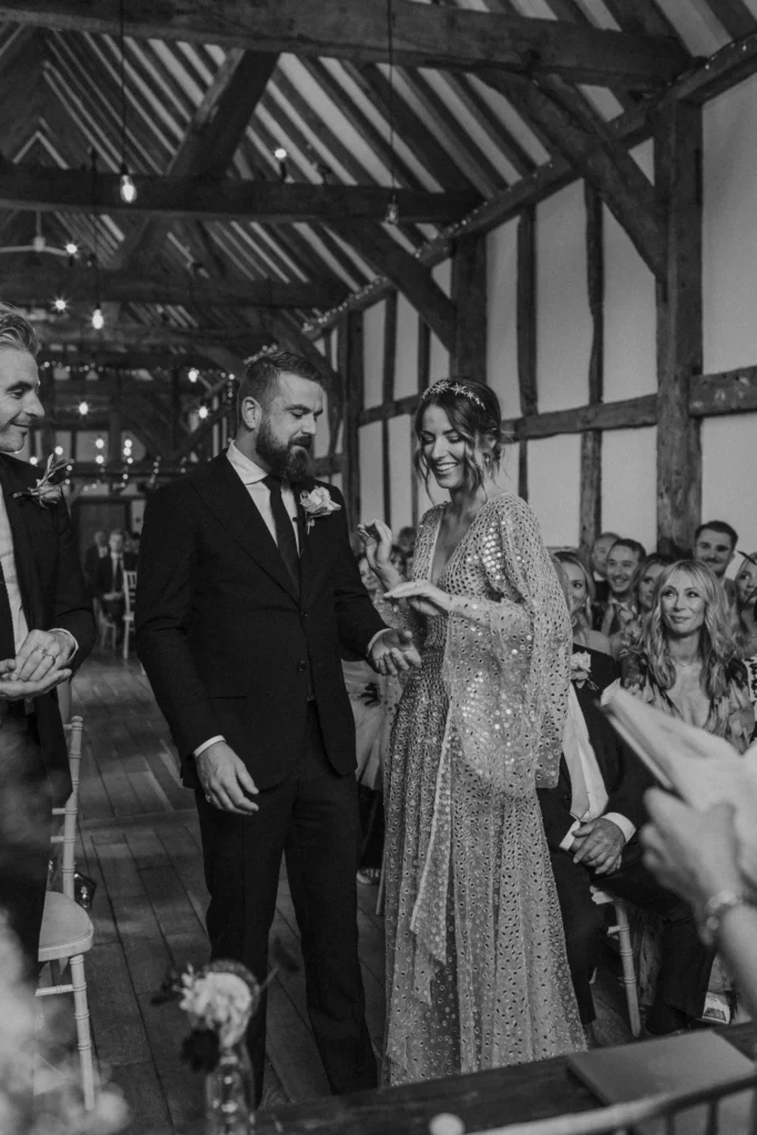 Photographer: Emma Wilder. Rustic barn wedding bride groom modern dress.