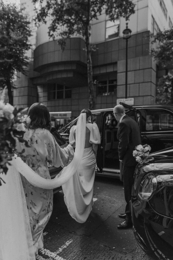 Photographer: Emma Wilder. Modern bride, London black cab, long veil.