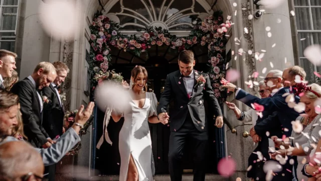 Photographer: Emma Wilder. Modern wedding couple, town hall, ceremony, pink confetti.