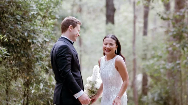 Photographer: Gavin Morgan James. Modern bride and groom, woodland wedding, modern bridal dress with leg open.