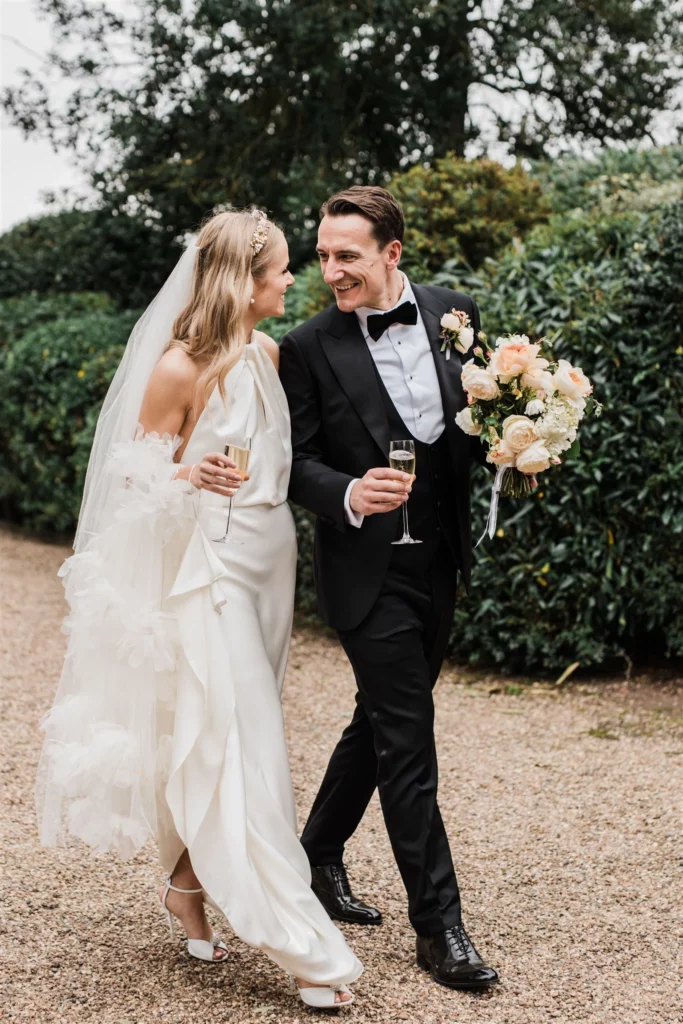 Photographer: Katie Rogers. Bride and groom, white off shoulder bridal dress, beige bridal bouquet