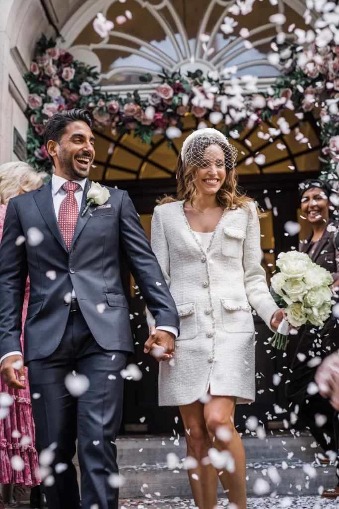 Photographer: Katie Rogers. London modern wedding reception, town hall, short bridal dress, confetti.