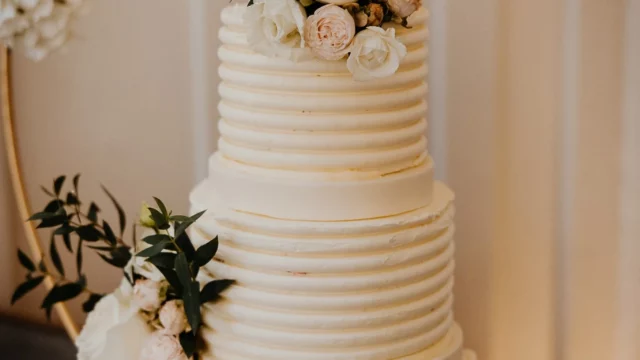 Cake Designer: Lindsay Pemberton. Wedding cake beige with floral decor.