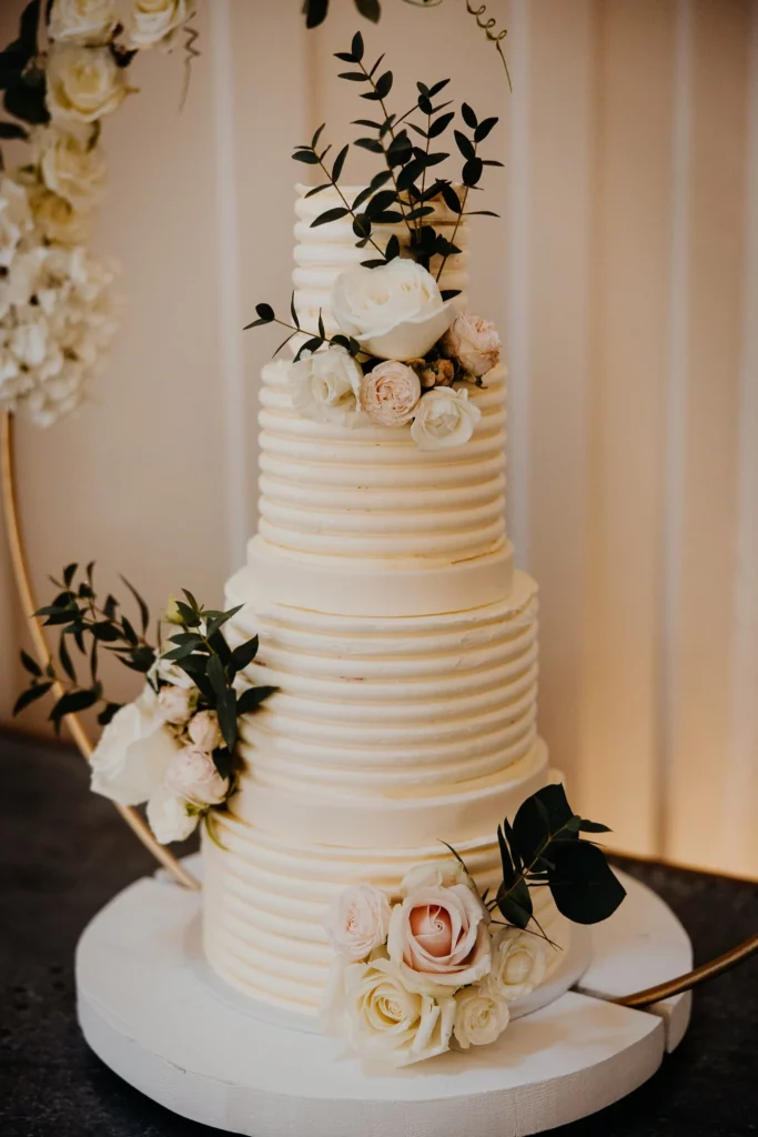 Cake Designer: Lindsay Pemberton. Wedding cake beige with floral decor.