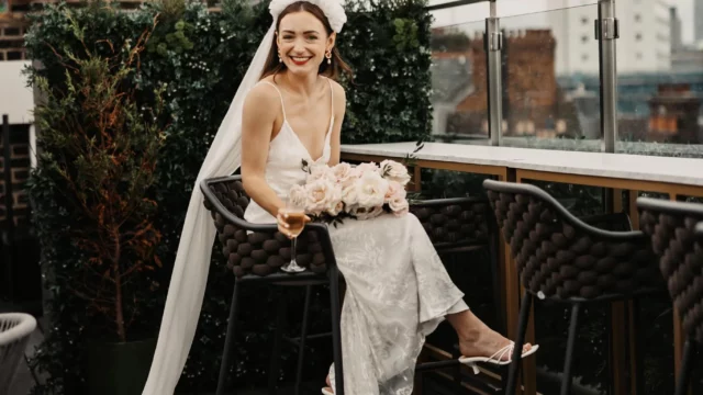 Photographer: Olegs and Rita Photography. Modern bridal dress, open shoulders, long veil, floral headpiece.