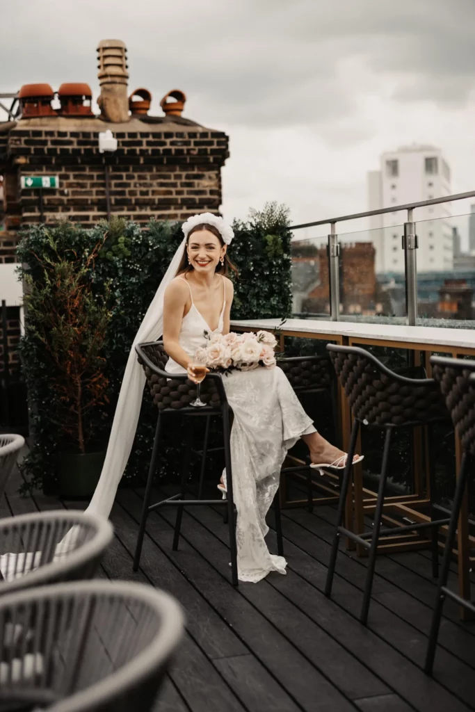 Photographer: Olegs and Rita Photography. Modern bridal dress, open shoulders, long veil, floral headpiece.