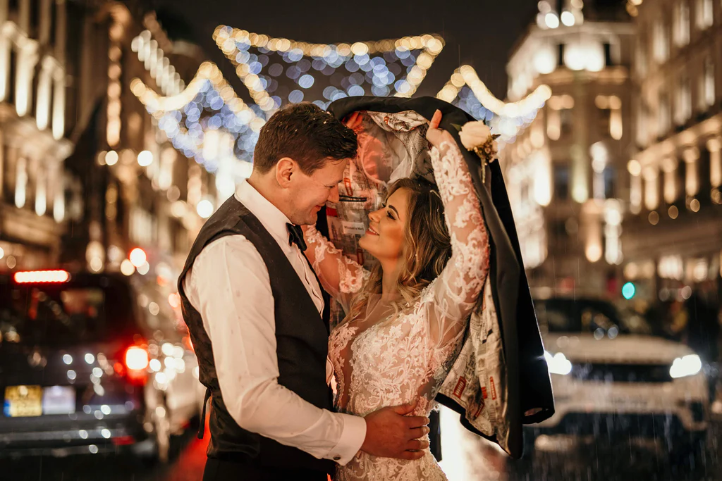 Photographer: Olegs and Rita Photography. London wedding bride groom, London regents street, black cab, Christmas lights.