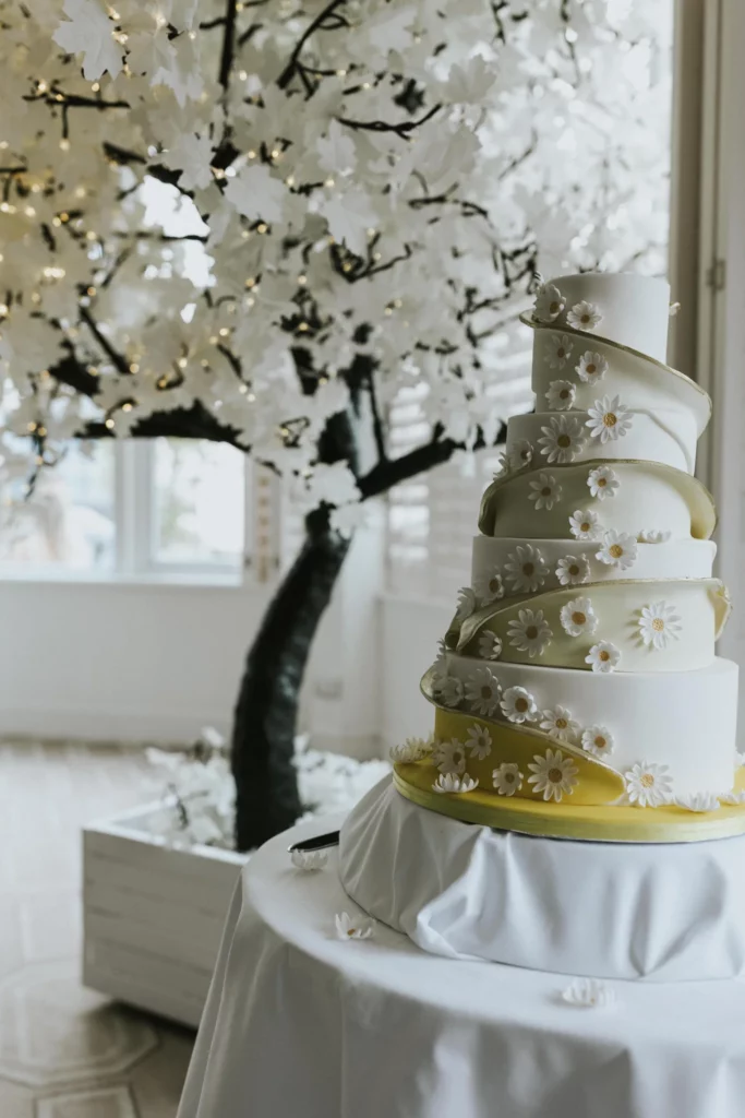 Cake Designer: Peboryon. White and yellow floral wedding cake.