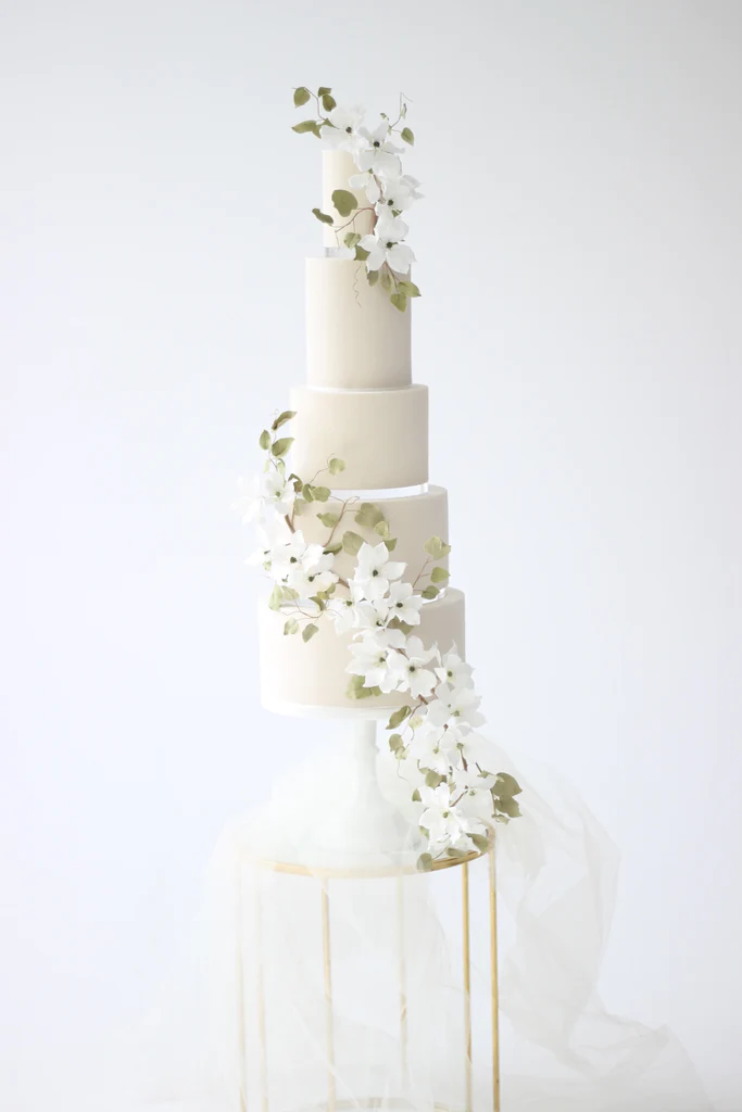 Cake Designer: Poppy Pickering Cake Design. White 5 tier wedding cake with floral decor.