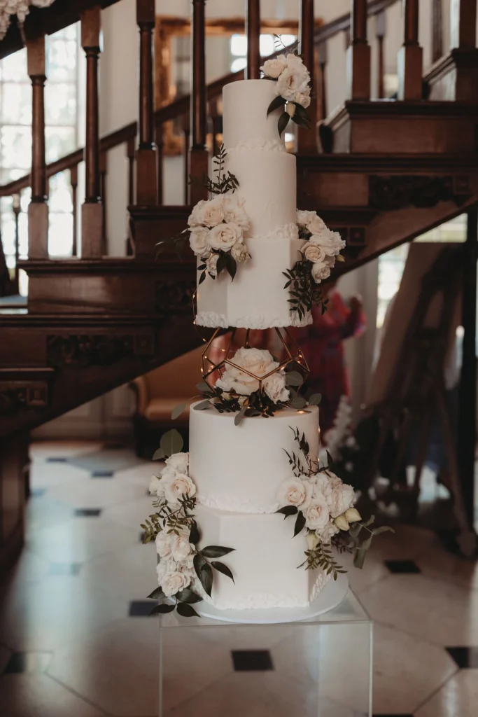 Cake Designer: RT Cakes, white floral wedding cake 5 tiers.