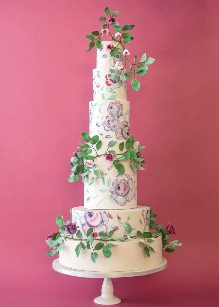 Cake Designer: Rosalind Miller Cakes. Floral decorated wedding cake 6 tiers, foliage.