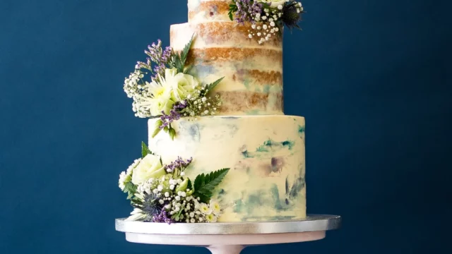 Cake Designer: Rosalind Miller Cakes. Rustic wedding cake 3 tiers with flower decorations.