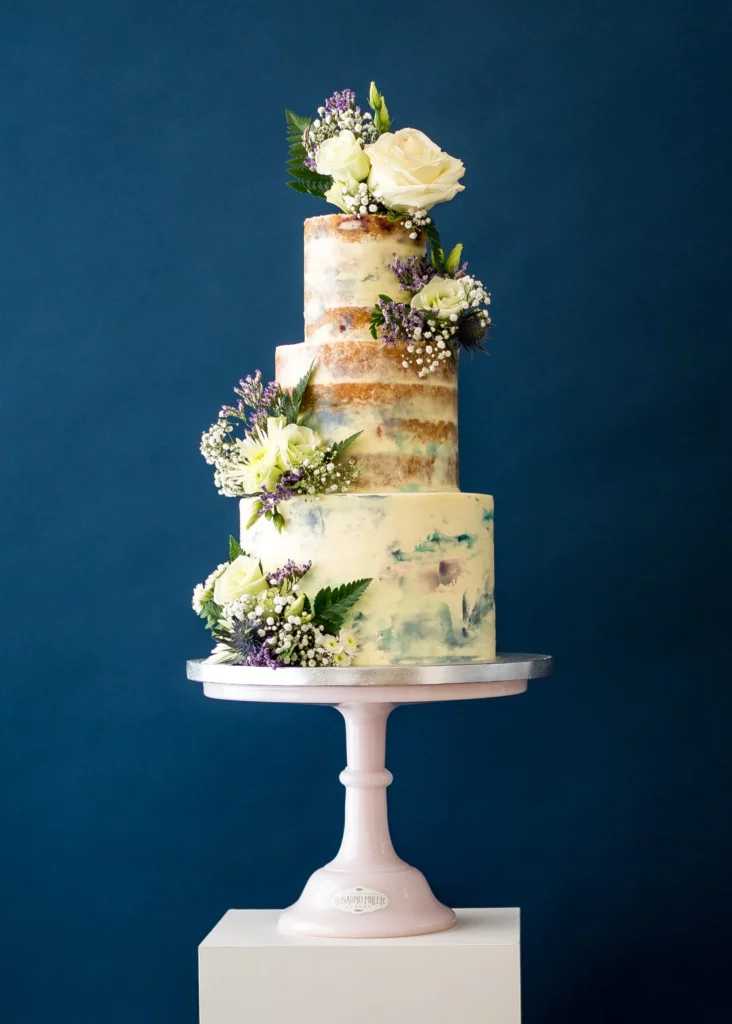 Cake Designer: Rosalind Miller Cakes. Rustic wedding cake 3 tiers with flower decorations.