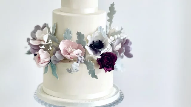 Cake Designer: Rosalind Miller Cakes. White wedding cake 3 tiers with lilac and purple edible sugar flowers.