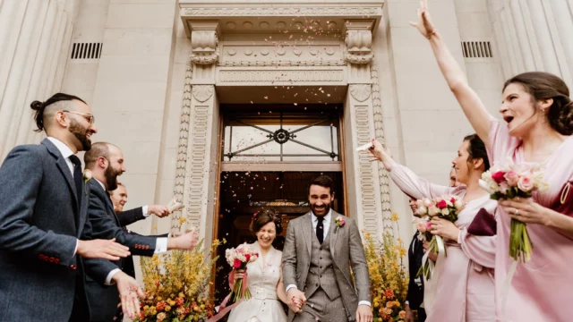 Photographer: Sharron Gibson. Bride groom wedding ceremony town hall, confetti.