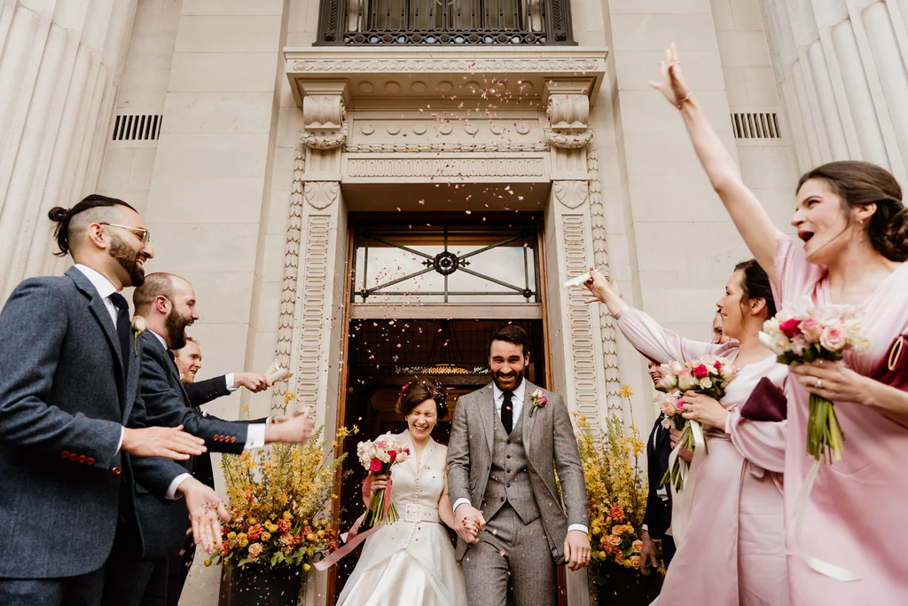 Photographer: Sharron Gibson. Bride groom wedding ceremony town hall, confetti.