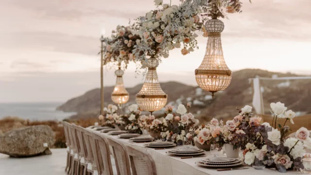 Event Planner: The Stars Inside. Elopement in Europe, coast, rocks and ocean view, Italian style, chandeliers, burnt orange, pastel dusty rose, beige wedding table.