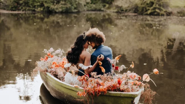 Event Planner: The Stars Inside. Elopement, bride and groom on the boat, dusty red and burnt orange floral arrangement wedding.