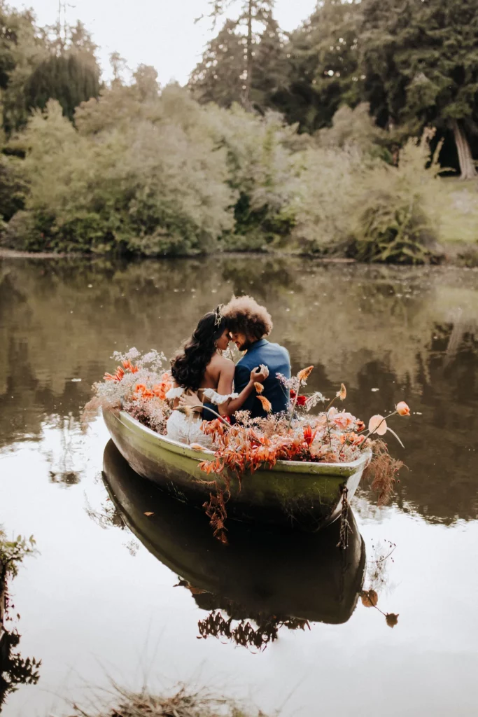 Event Planner: The Stars Inside. Elopement, bride and groom on the boat, dusty red and burnt orange floral arrangement wedding.