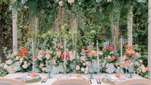 Event Planner: Emma Westacott. pastel blue, orange, white, pink floral arrangement. pastel blue wedding tableware.