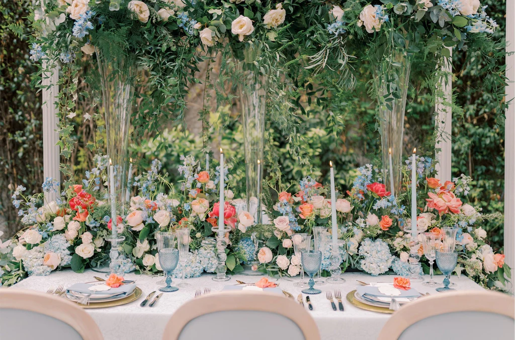 Event Planner: Emma Westacott. pastel blue, orange, white, pink floral arrangement. pastel blue wedding tableware.