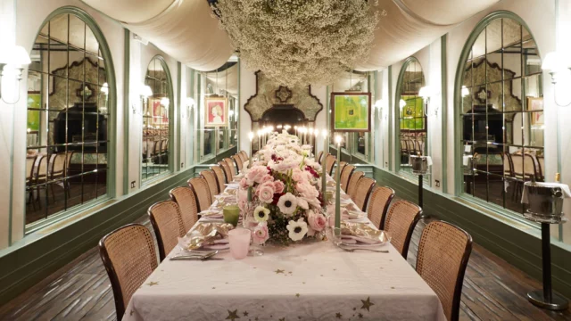 Florist: Wild At Heart. Wedding floral arrangement table, soft pink, wedding table, white handing ceiling florals.